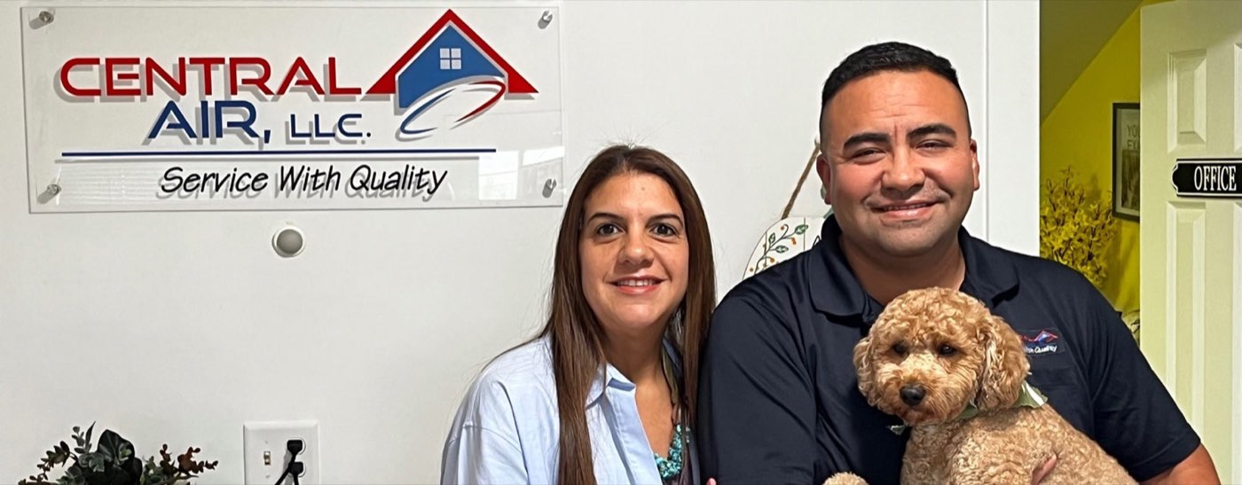 The owners of Central Air, LLC in the Brookfield office beneath the company sign
